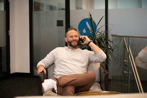 Plumbing CEO Sitting While Talking To Organizer Inviting Him To Become Conference Speaker