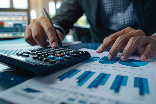 Man Using Calculator To Check Concepts Learned During Plumbing Business Training