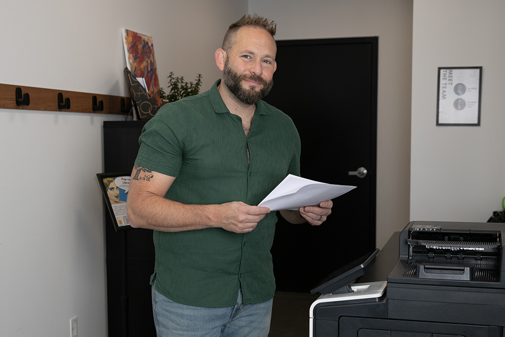 Business Coach Holding Papers Related To His Plumbing Company